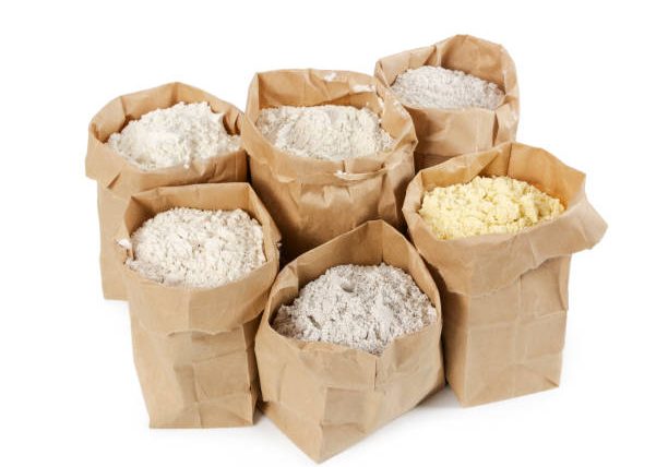 Flour and flour mixture in paper bags isolated on white background.